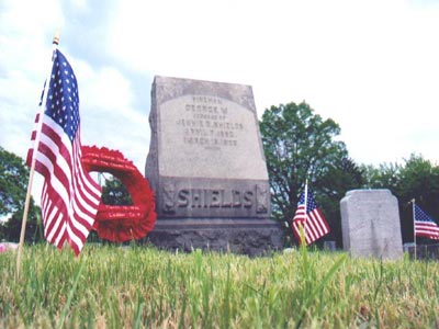 Flags and wreath at the grave site of Fireman George Shields