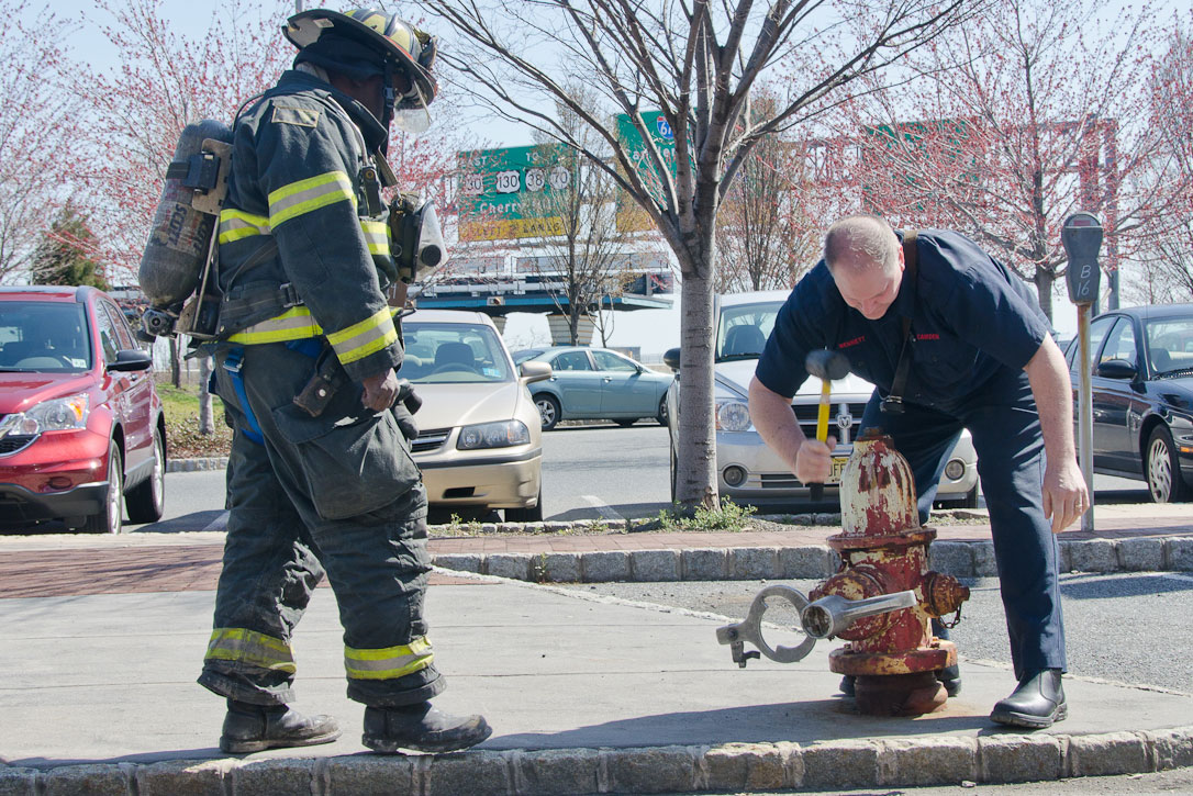 Ken White and Howard Bennett working a hydrant at a fire on Rutgers Street, March 14, 2012