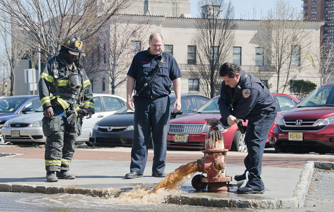 Ken White, Howard Bennett, and Gabe Rivera at a hydrant on Rutgers Street, March 14, 2012