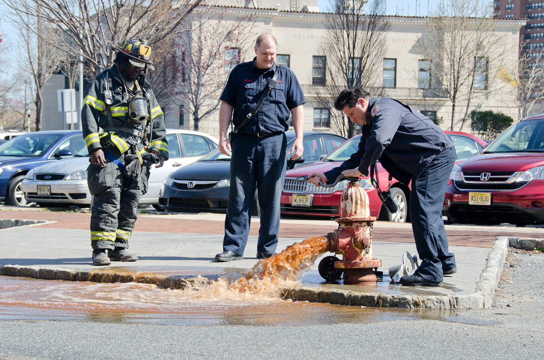 Ken White, Howard Bennett, and Gabe Rivera at a hydrant on Rutgers Street, March 14, 2012