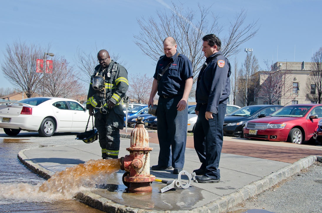 Ken White, Howard Bennett, and Gabe Rivera at a hydrant on Rutgers Street, March 14, 2012