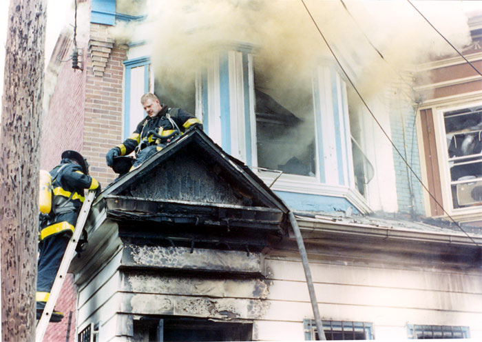 Members from Rescue Company 1 attempt to stretch a hose line through the 2nd floor at 813 North 8th Street, June 25, 1995