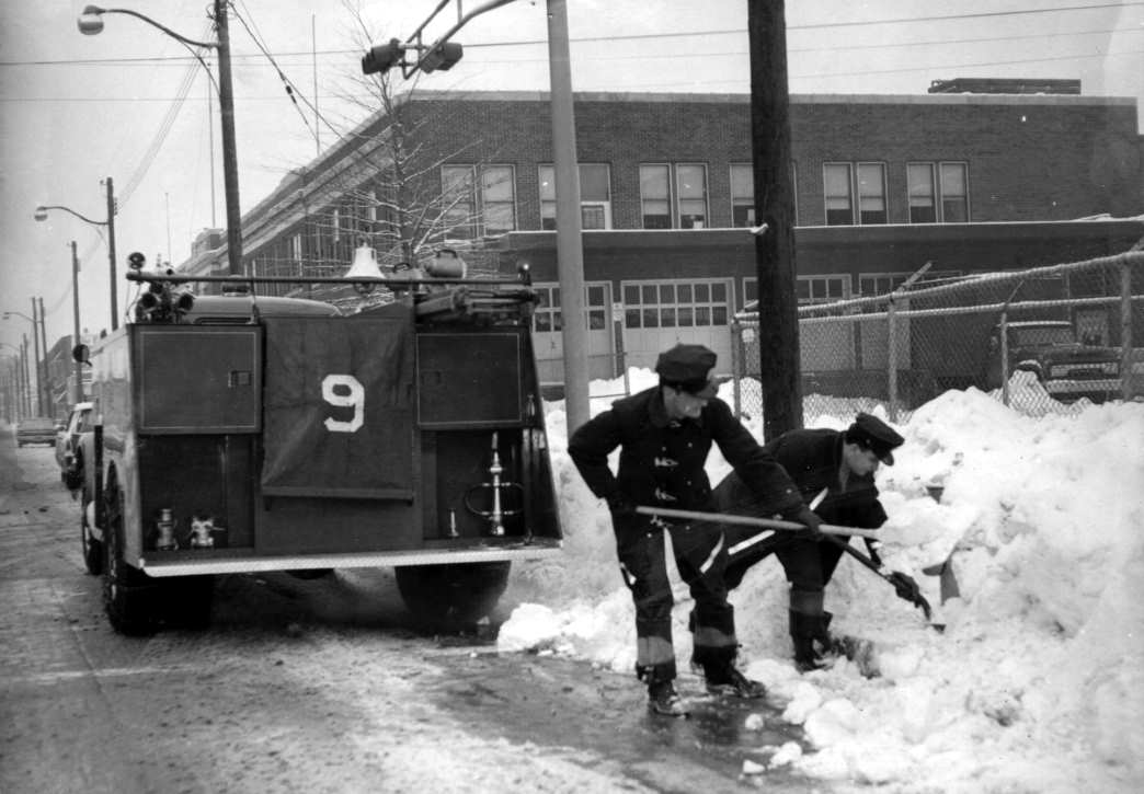 Engine Company 9 removing snow from fire hydrant on Federal Street at 17th Street, 1967