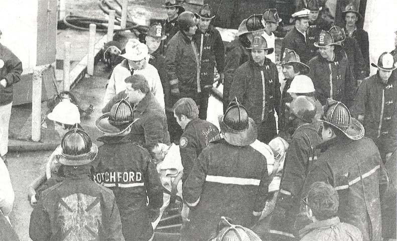 An injured Phillip Maycott being loaded into an ambulance at the General Radio Company fire, March 3, 1970