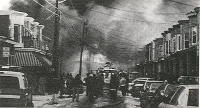 Heavy smoke as fire engulfs seven homes and cars on the 1200 block of Morton Street, Dec. 28, 1995