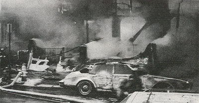 Heavy smoke as fire engulfs seven homes and cars on the 1200 block of Morton Street, Dec. 28, 1995