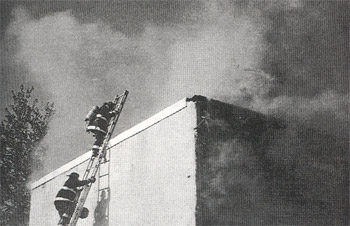 After venting the roof at Newton Avenue and Royden Streets, Ladder Co. 2 members retreat, May 20, 1997