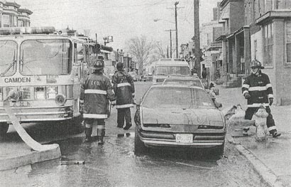 March 22, 1995, Engine Company 1 members flush a hydrant blocked by a parked car