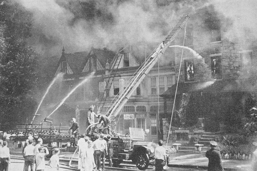 Firemen are shown attempting to check flames which destroyed this row of buildings along Cooper Street