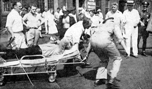 A victim of the Hollingshead fire carried on a stretcher to a waiting ambulance, Camden, NJ, July 30, 1940