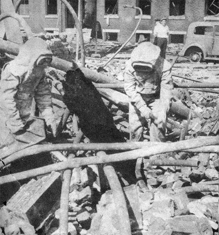 Rescue workers search the ruins of the Hollingshead plant, Camden, NJ, July 1940