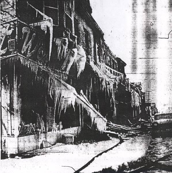 Huge icicles cover wreckage of three buildings destroyed in fire on Broadway at Chestnut Street, January 14, 1964