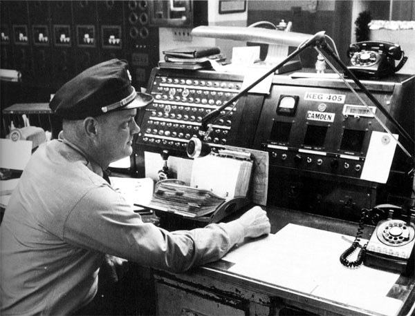 The old Fire Alarm Room on the eighth floor of City Hall. Fire Captain Philip Farrow as Chief Dispatcher at the main radio position, circa 1965