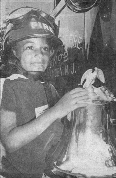 Lynette Hegdspeth of 1419 Park Boulevard rings bell of Ladder 2 Truck, August 13, 1968