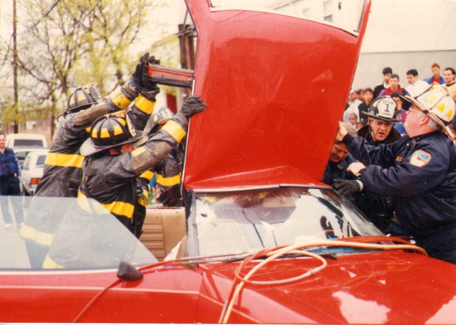 Rescue 1 and Engine 11 aiding pregnant woman trapped in car, State Street and Harrison Avenue, Cramer Hill, 1991