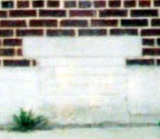 Coal chute at 59 Ablett Village, Camden, showing the cemented-over access hole to the outside coal bin, August 2004