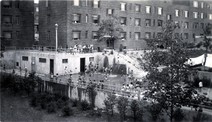 View from third floor balcony in Building Number 9, looking down on showers, July 1940
