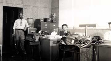 The management office at Branch Village, with Oliver Bond standing, 1941
