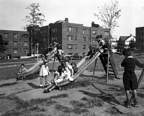 Playground at the rear of Westfield Acres showing archways beneath the buildings, 1938