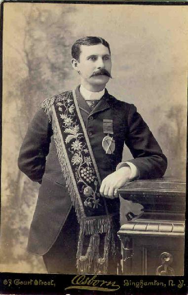 Early Red Men member wearing sash, badge, and ceremonial pouches