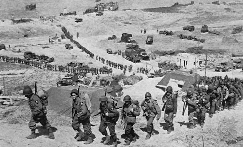 On D plus 1 (June 7), troops of the 2nd Infantry Division file up the bluff from Easy Red sector toward Saint-Laurent-sur-Mer