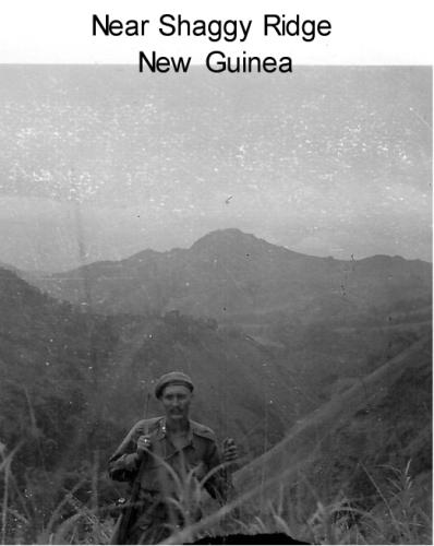Captain Frederick carrying a rifle in New Guinea, late 1943