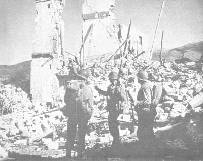 Ruined buildings in Mignano are surveyed by a three-man patrol from the 3d Division
