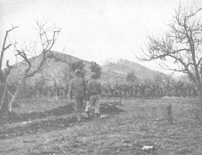 155-mm howitzers throw a barrage of smoke and high explosive shells on Mount Lungo