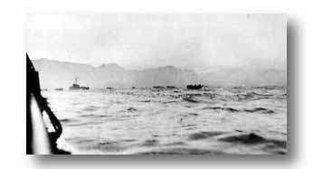 Small landing craft (LCVPs) move inland preparatory to invasion on gray morning of September 9