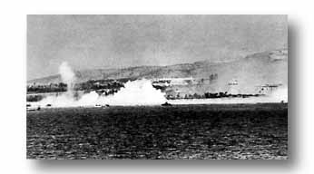 German artillery throws geyser while Allied smoke shields landing at Paestum