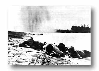 Naval beach party assumes the horizontal when enemy plane skips in at Salerno