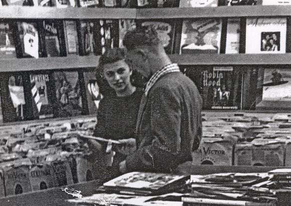 Shirley Berul helps a customer in Albert Berul's record shop on Haddon Avenue, December 1946