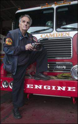Bob Bartosz in front of a fire truck at the Liberty Street Fire Station in Camden