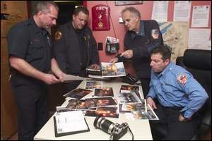 Camden Firefighters looking through old photos taken by Bob Bartosz
