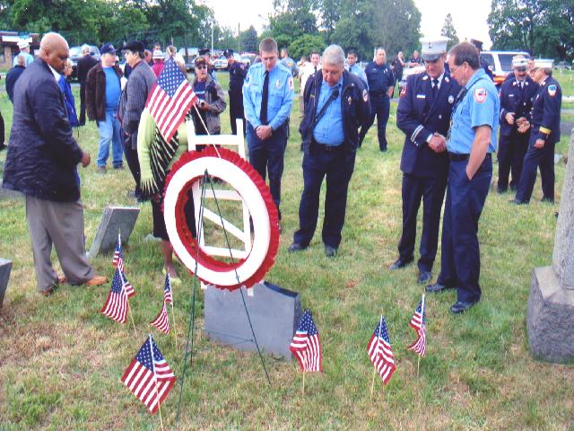 Firefighters admiring the new headstone at the gravesite of Hillman