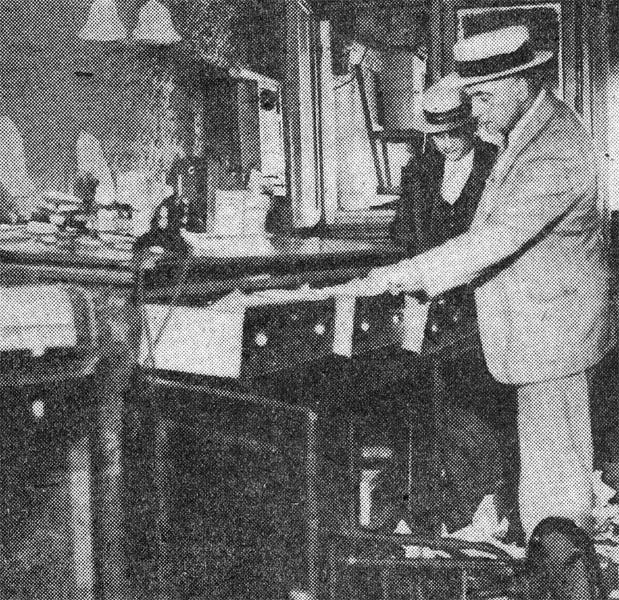 Detective Clifford Del Rossi searching for fingerprints at brewery, June 4, 1933