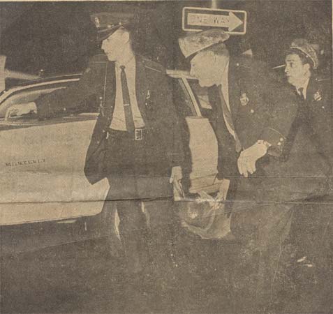 Camden police officers at scene of patrol car crash, 10th and Federal Streets, 1967 — Officer Mike Lupico at far right