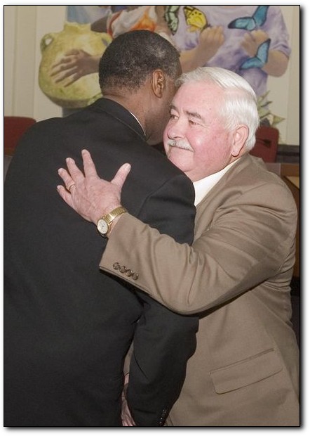 Retired Camden Police Sgt. Frank Howard accepts congratulations from Councilman Gilbert Wilson