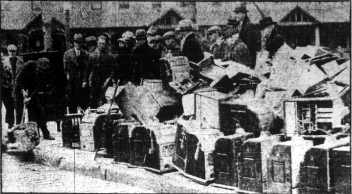 Confiscated slot machines being stacked in front of police headquarters, February 15, 1928