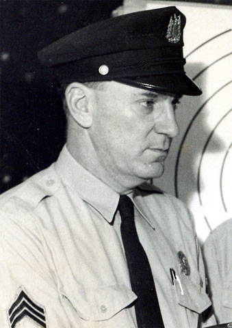 Sgt. William Schultz demonstrating handgun, 1950s