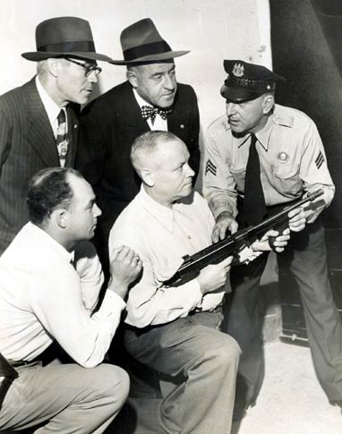 Sgt. William Schultz demonstrating Thompson submachine gun, 1950s