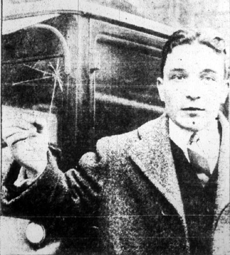 Leon Fuhrman holding the screw missile, with Abe Fuhrman's automobile, February 9, 1928