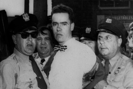 Sergeant Earl Wright (wearing sunglasses) with killer Howard Unruh in custody, September 6, 1949