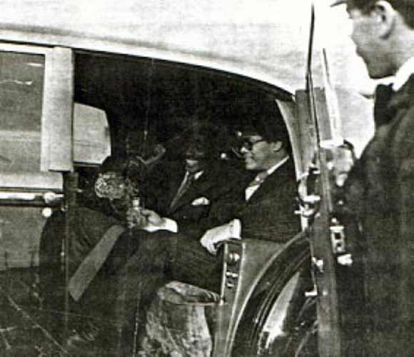 Major Coxson pouring Sonny a drink