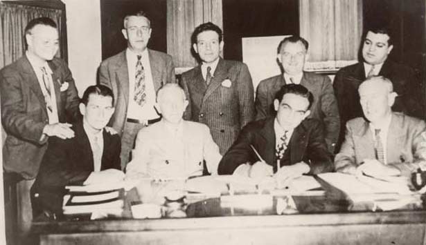 A Johnny Toomey contract signing — Johnny Toomey is seated at far left