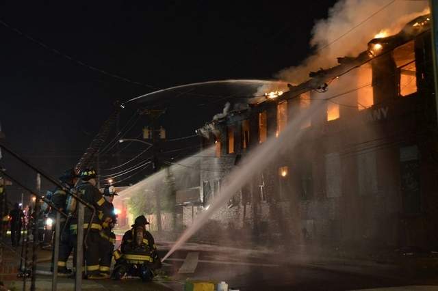 Firefighters try to contain a blaze at 6th Street and Carl Miller Boulevard in Camden