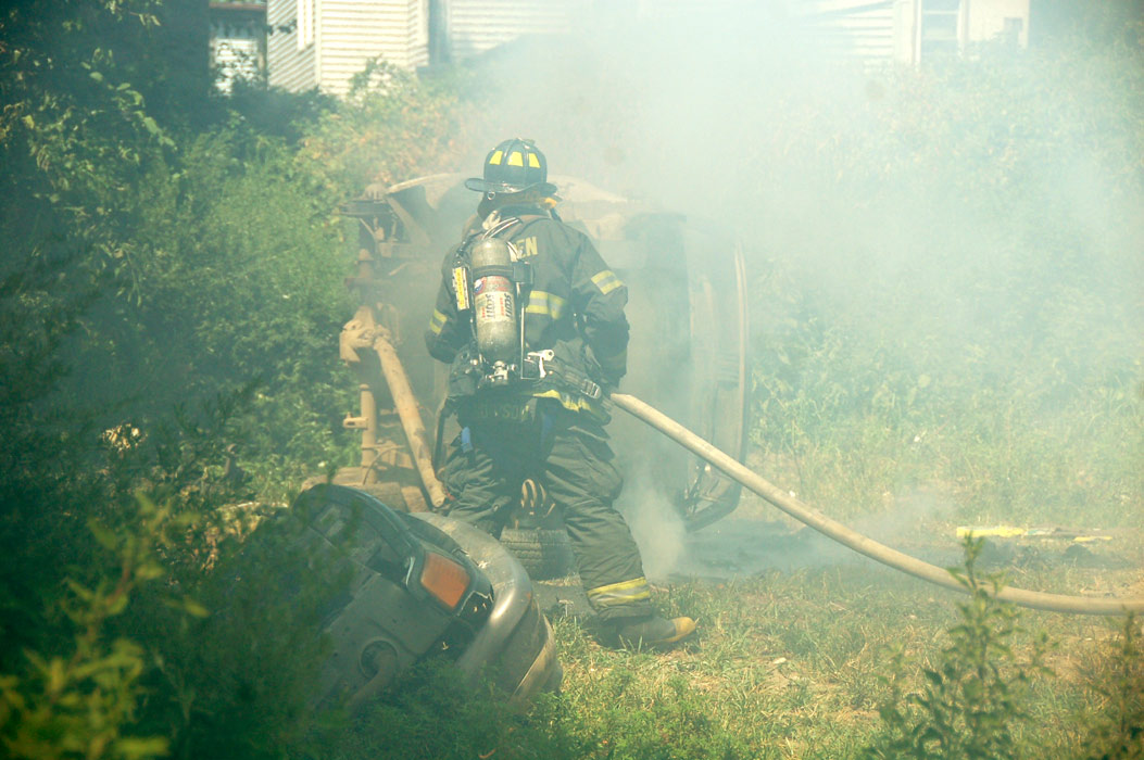 Frank Thompson goes into the smoke to put out the hot spots (color-adjusted)