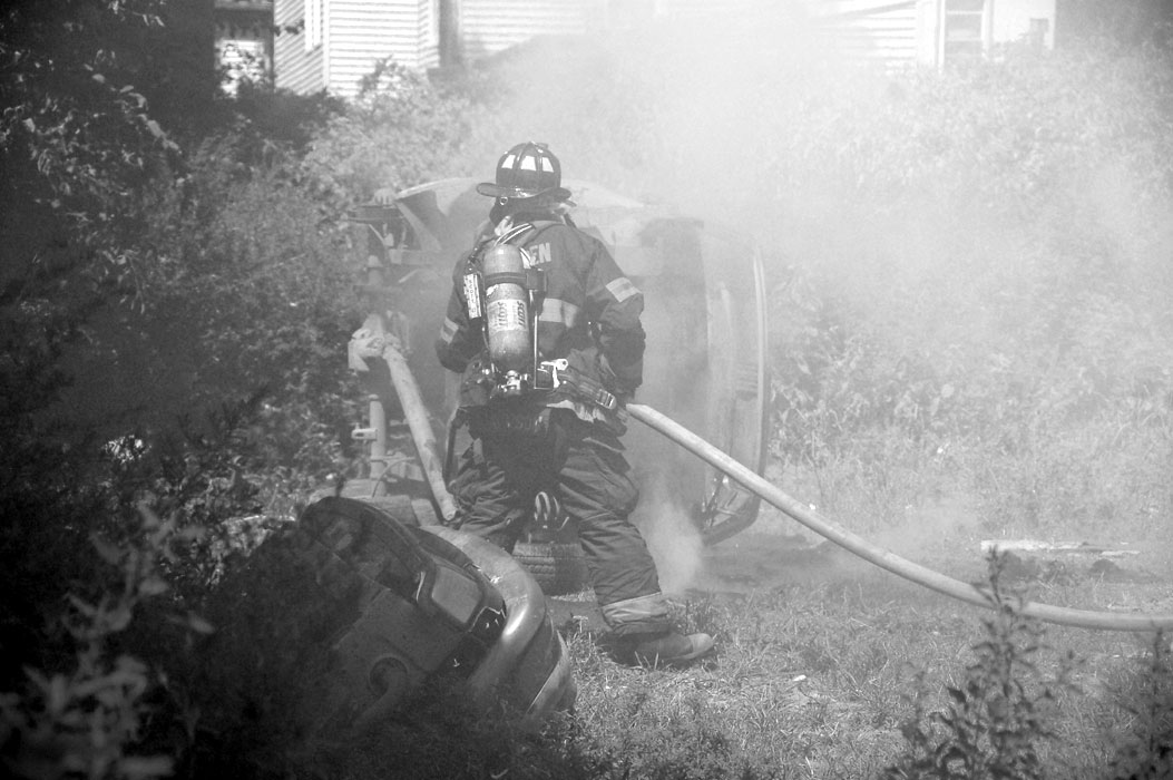 Frank Thompson goes into the smoke to put out the hot spots (black and white)