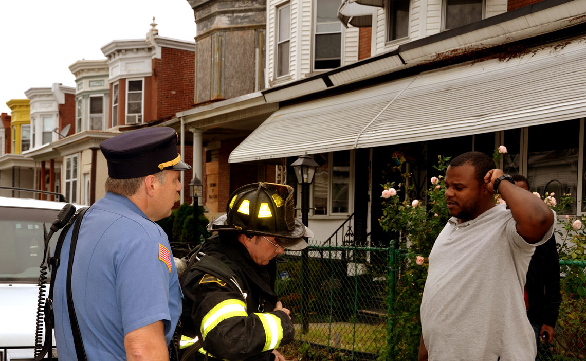 Battalion Chief Ed Glassman and Captain Warren Everett talking with civilian