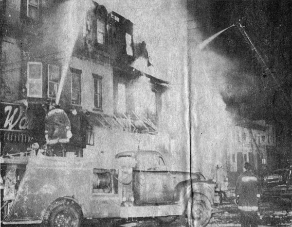 Roaring flames obscure 1101 Broadway as fire destroys the building, January 14, 1964